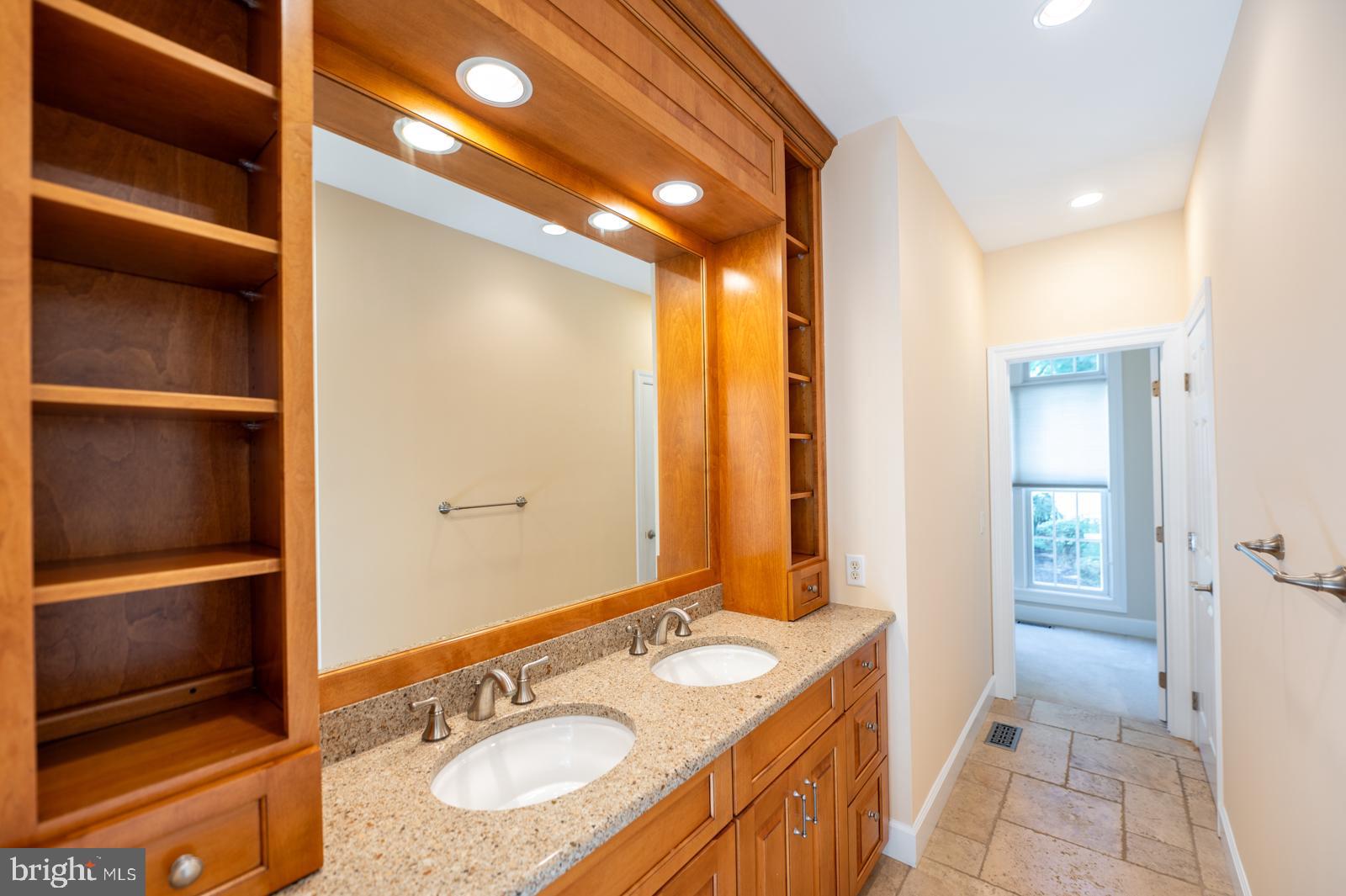 1060 West King Road Malvern, PA 19355 - Photo 33 of 90 a bathroom with a granite countertop sink and a mirror