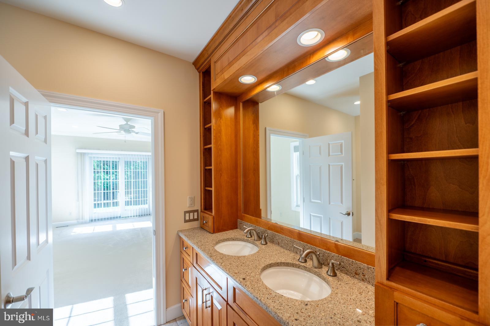 1060 West King Road Malvern, PA 19355 - Photo 34 of 90 a bathroom with a granite countertop sink and a mirror