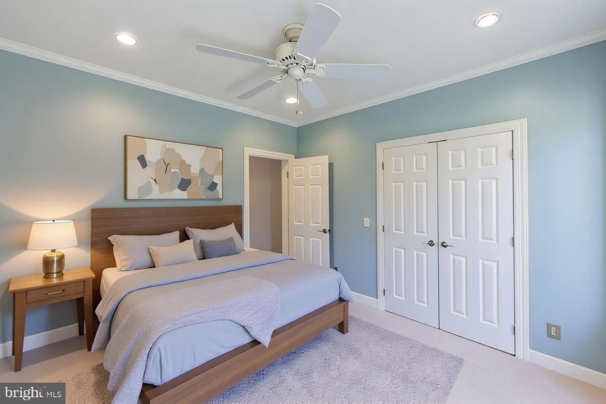 1060 West King Road Malvern, PA 19355 - Photo 52 of 90 a bedroom with a large bed and a chandelier