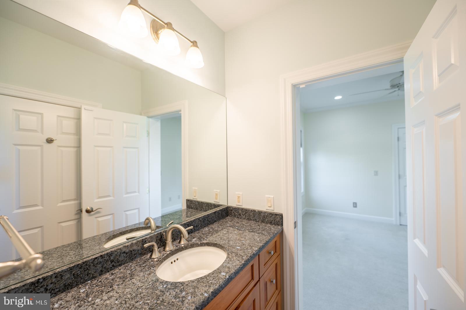 1060 West King Road Malvern, PA 19355 - Photo 53 of 90 a bathroom with a granite countertop sink and a mirror