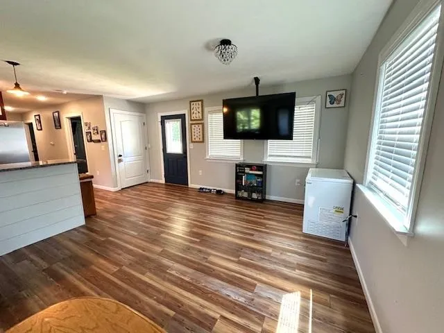 a view of a livingroom with furniture and a flat screen tv