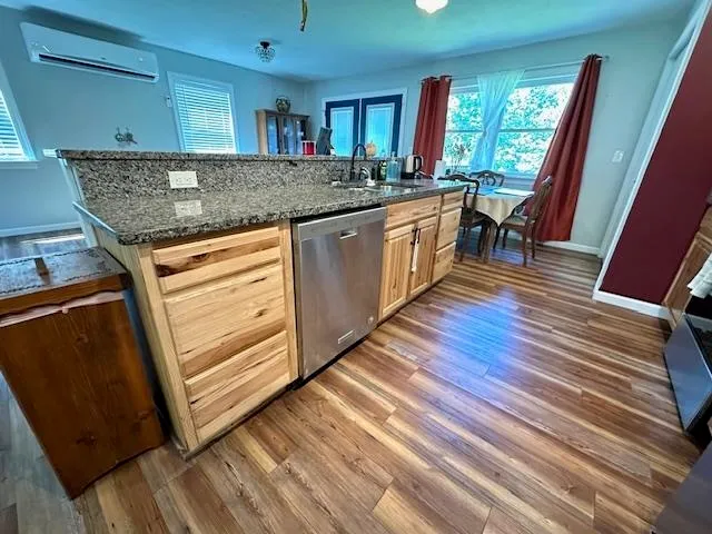 a kitchen with stainless steel appliances granite countertop a stove a sink and a refrigerator