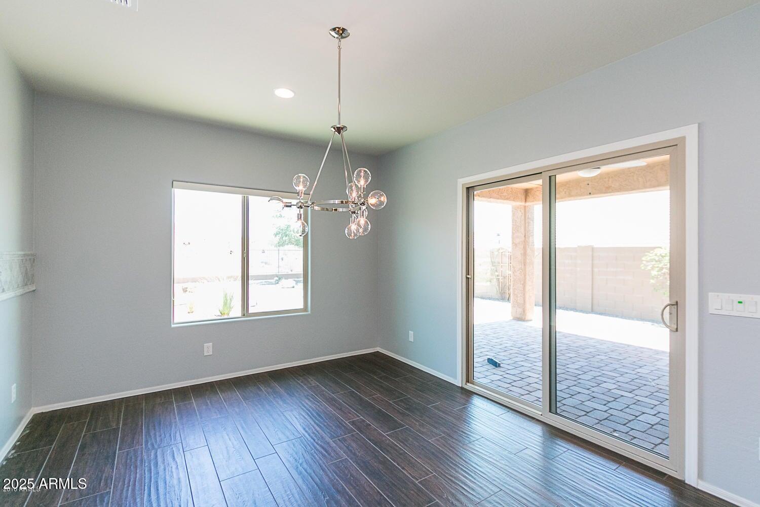 26833 North 14th Lane Phoenix, AZ 85085 - Photo 12 of 55 a view of an empty room with wooden floor and a window