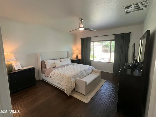 a bedroom with a bed and a chandelier