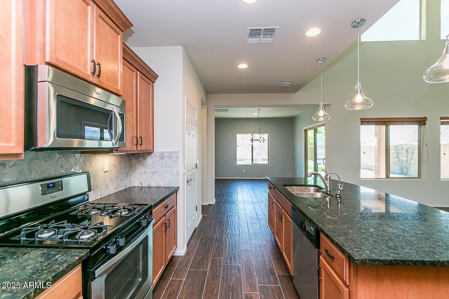26833 North 14th Lane Phoenix, AZ 85085 - Photo 2 of 55 a kitchen with sink stove and cabinets