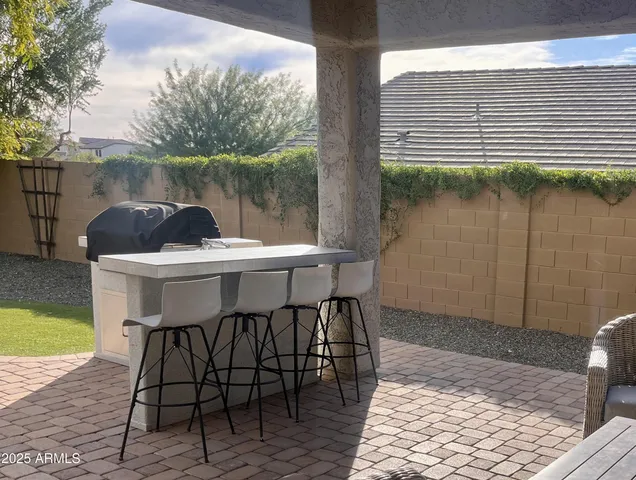 a patio with table and chairs