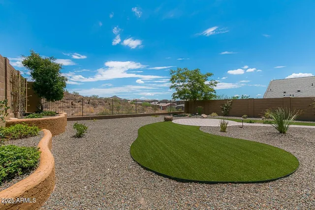 a view of a swimming pool with a yard and outdoor seating