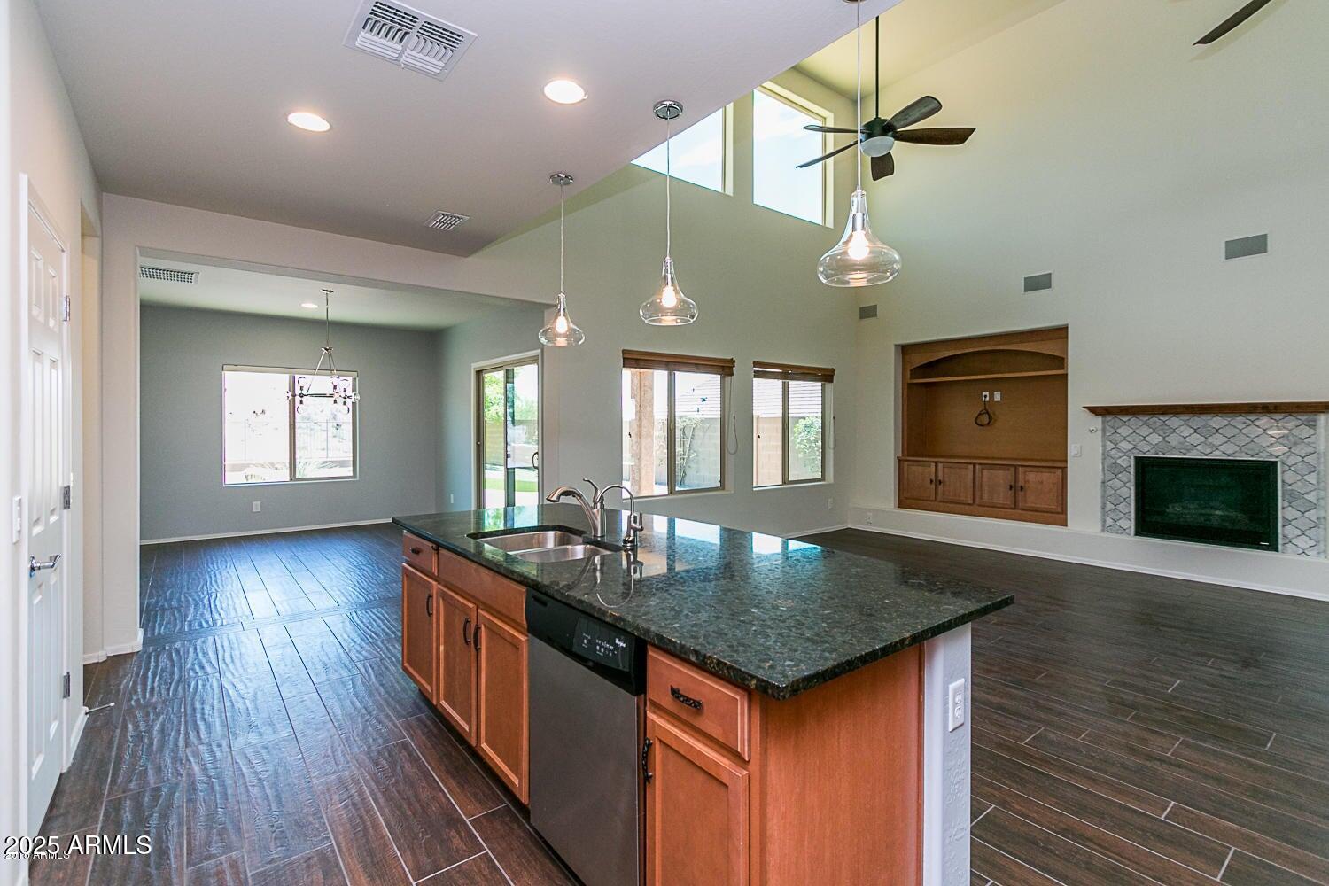 26833 North 14th Lane Phoenix, AZ 85085 - Photo 4 of 55 an open kitchen with a chandelier and wooden floor