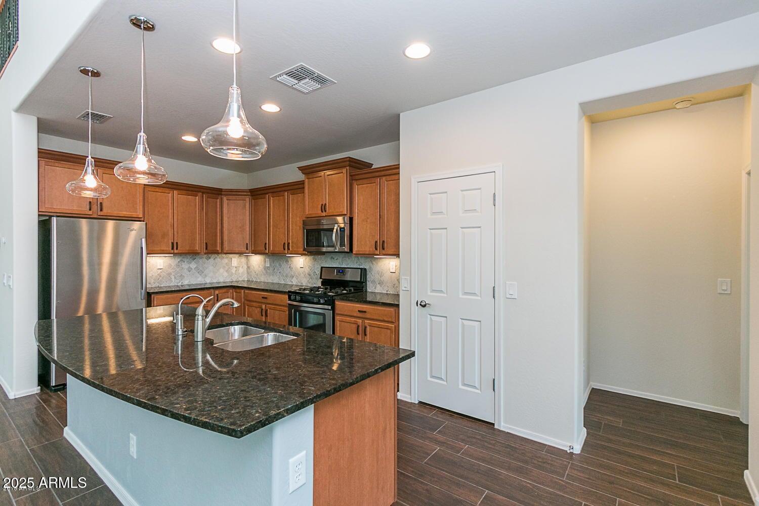 26833 North 14th Lane Phoenix, AZ 85085 - Photo 5 of 55 a kitchen with stainless steel appliances granite countertop a sink a refrigerator and a stove top oven