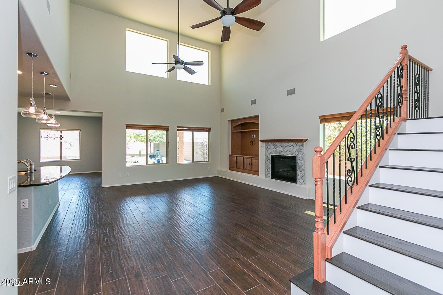 26833 North 14th Lane Phoenix, AZ 85085 - Photo 8 of 55 a view of a livingroom with wooden floor a ceiling fan and windows