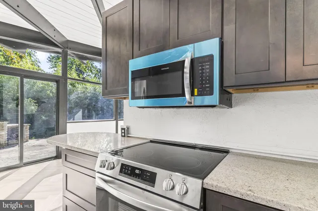 a kitchen with granite countertop a sink and a stove