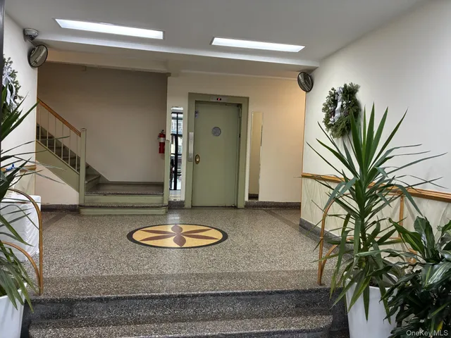 a view of a room with wooden floor and a window