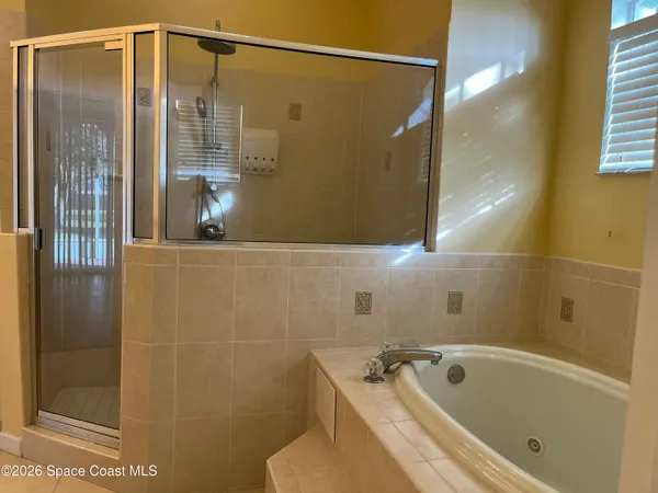 a bathroom with a tub and shower