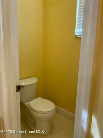 a bathroom with a white toilet and sink