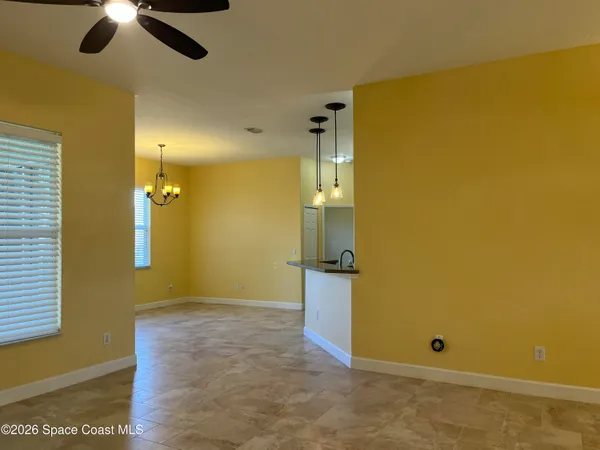 a view of a kitchen with an empty space and a window