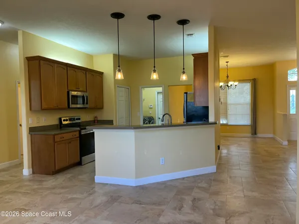 a kitchen with stainless steel appliances granite countertop a sink and a stove