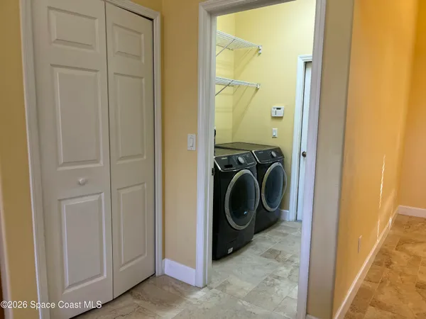 a view of a kitchen with a sink and chandelier