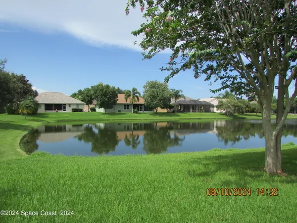 a view of a lake with a house in the background
