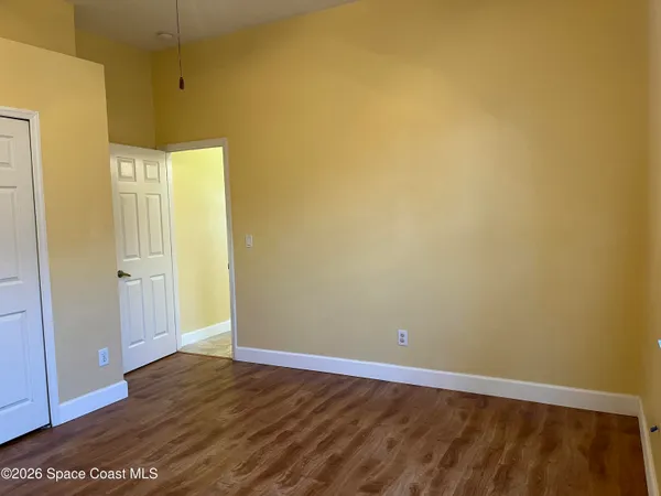 a view of a living room a flat screen tv and a large window