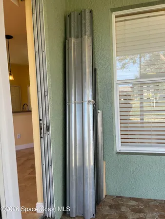 a view of a porch with a floor to ceiling window and a yard