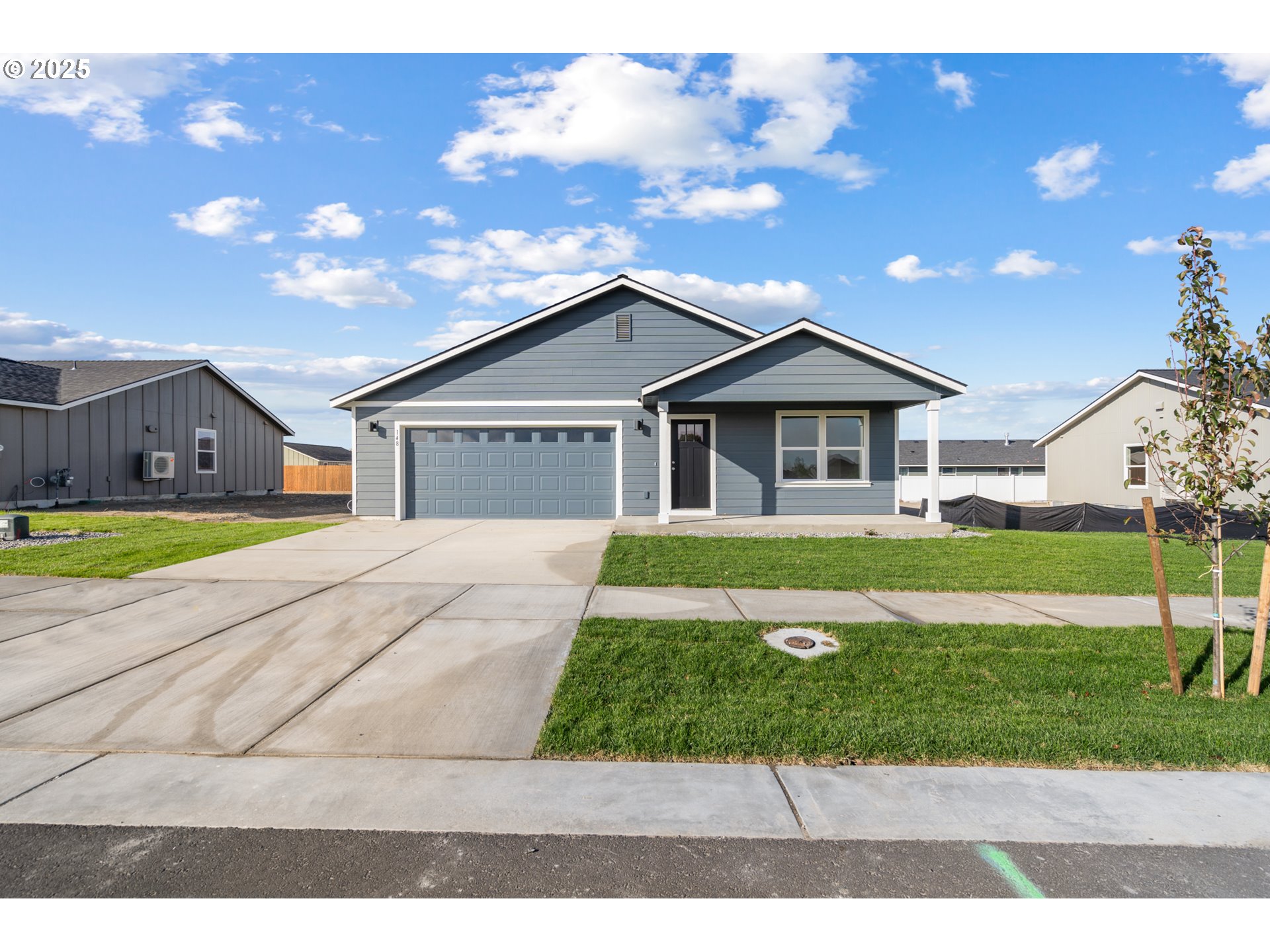 148 Southwest Eagle Drive Boardman, OR 97818 - Photo 23 of 27 a front view of a house with a yard