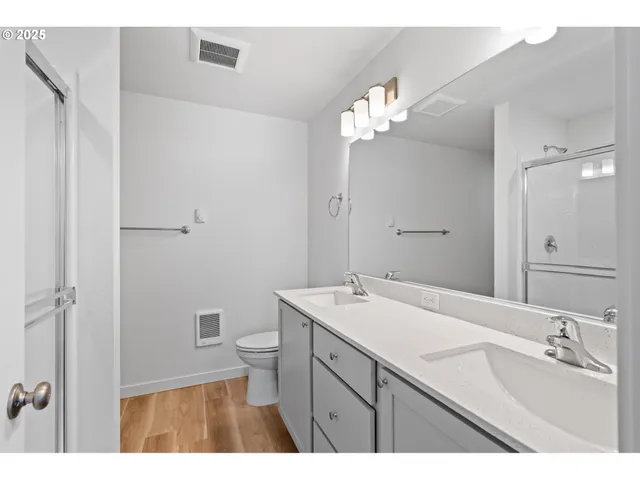a bathroom with a tub a sink and mirror