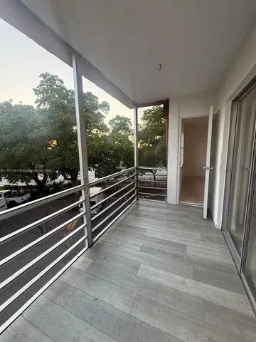 a view of a room with wooden floor and iron stairs