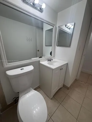 a white toilet sitting next to a bathroom sink