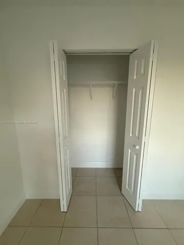 an empty room with a empty space and windows