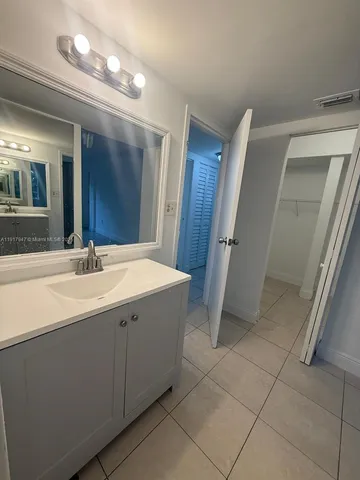 a white toilet sitting next to a bath tub