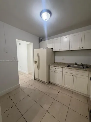 a kitchen with cabinets and window