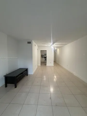 an empty room with a fireplace and a cabinet