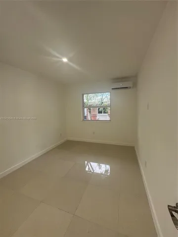 a view of an empty room and a window