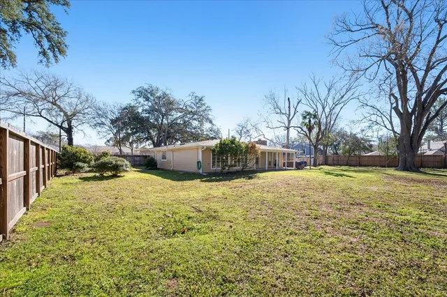 a backyard of a house with large trees
