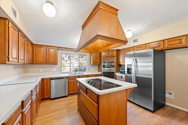 a kitchen that has a sink and a refrigerator