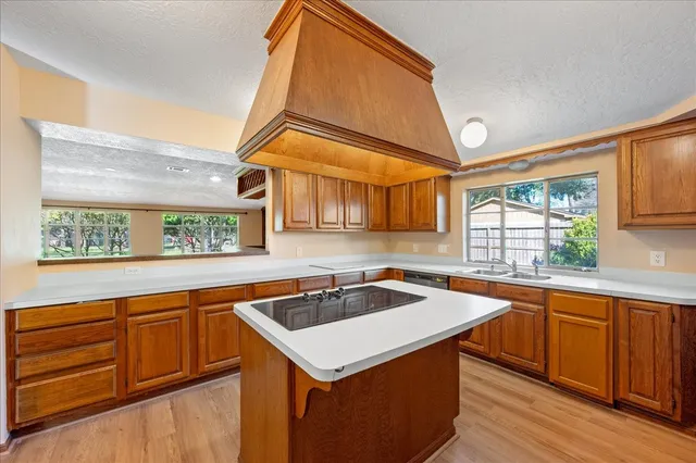 a kitchen that has a sink and a stove in it