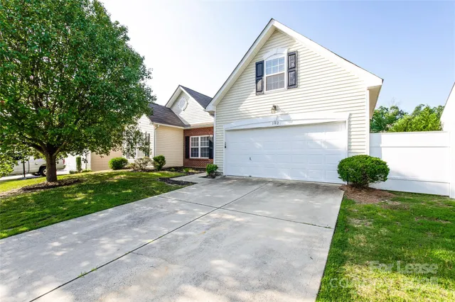 a view of a white house with a yard