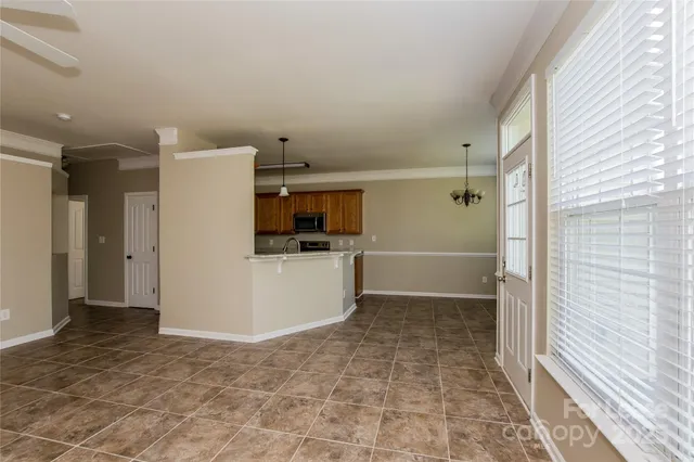 a view of kitchen with refrigerator and cabinets