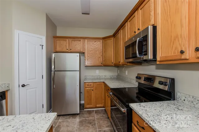 a kitchen with a refrigerator stove and microwave