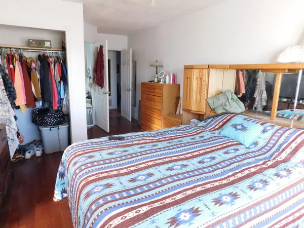 a bed sitting in a bedroom next to a window