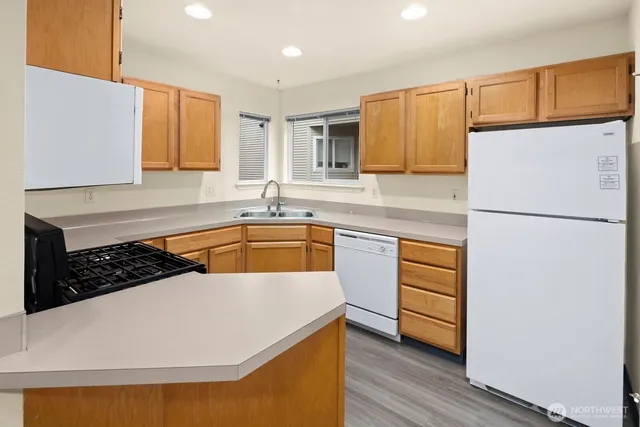 a kitchen with a sink stove top oven and cabinets