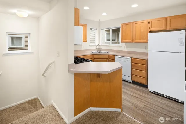 a white refrigerator freezer and a stove sitting inside of a kitchen