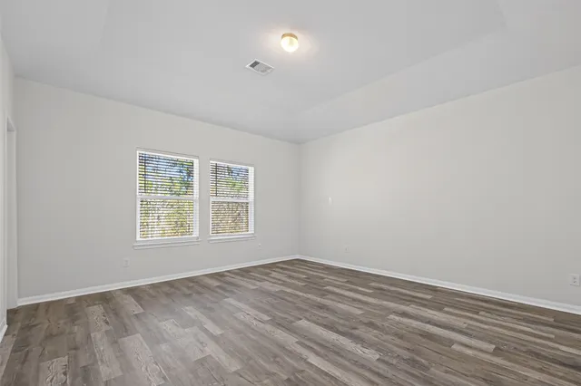 a view of an empty room and wooden floor
