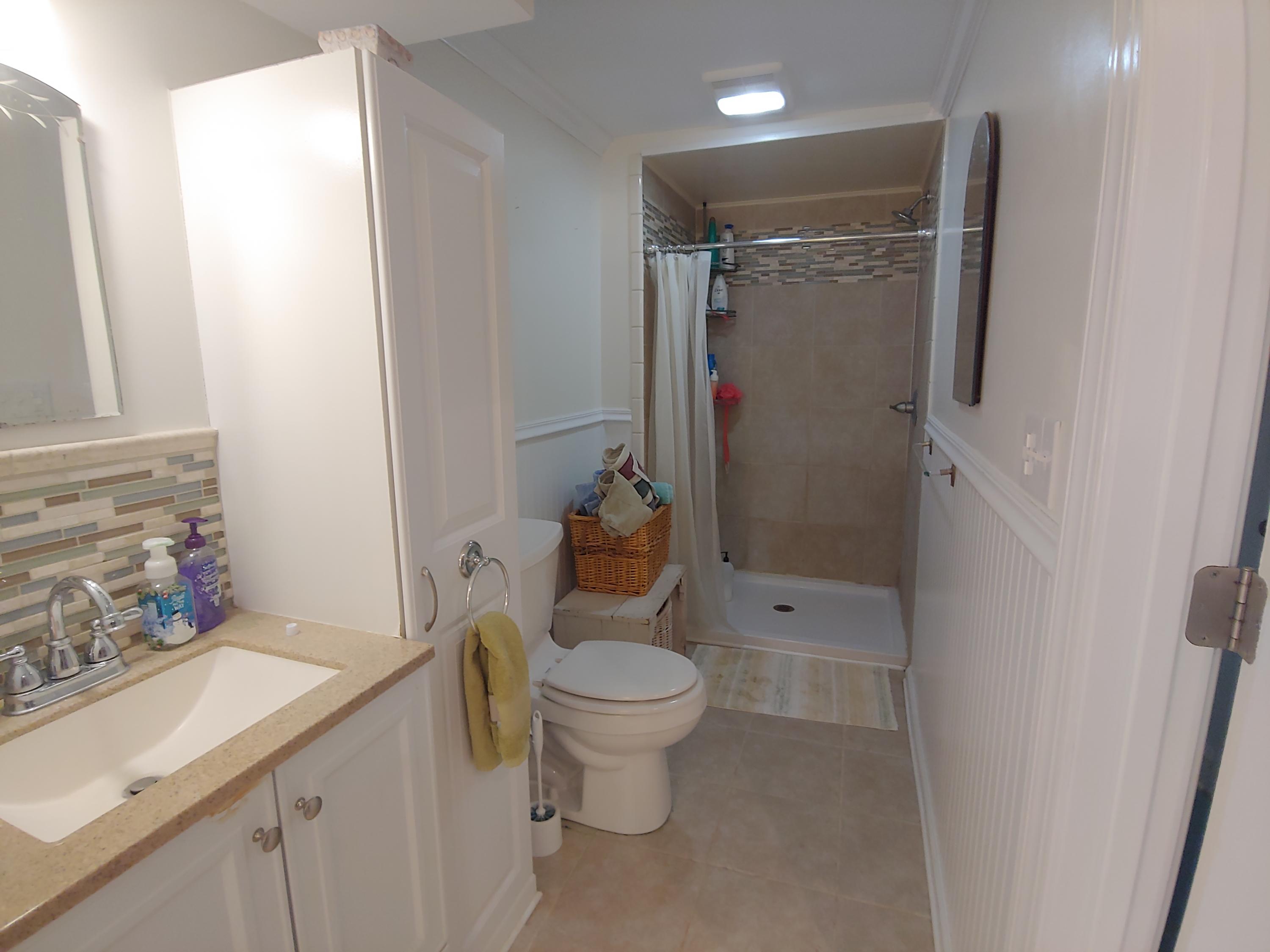 9313 Museville Road Sandy Level, VA 24161 - Photo 11 of 41 a bathroom with a granite countertop sink toilet and shower