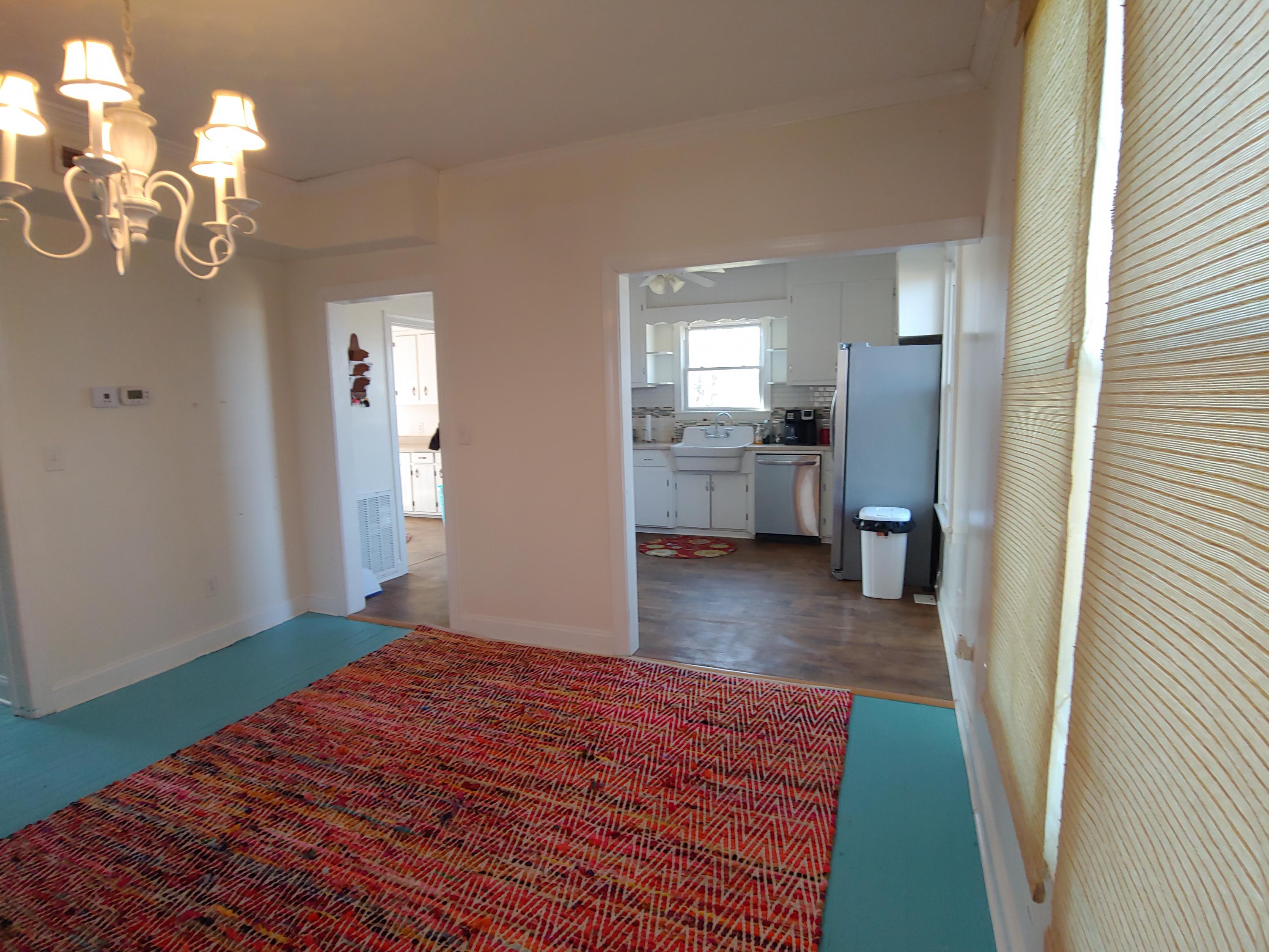 9313 Museville Road Sandy Level, VA 24161 - Photo 30 of 41 a bedroom with a bed and chandelier