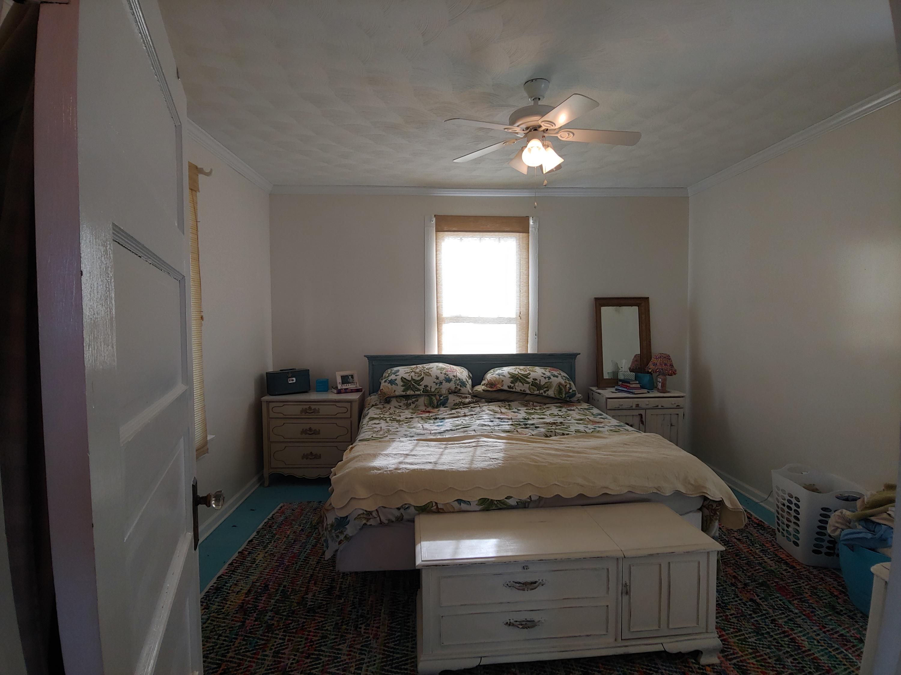9313 Museville Road Sandy Level, VA 24161 - Photo 31 of 41 a bedroom with a bed and a chandelier