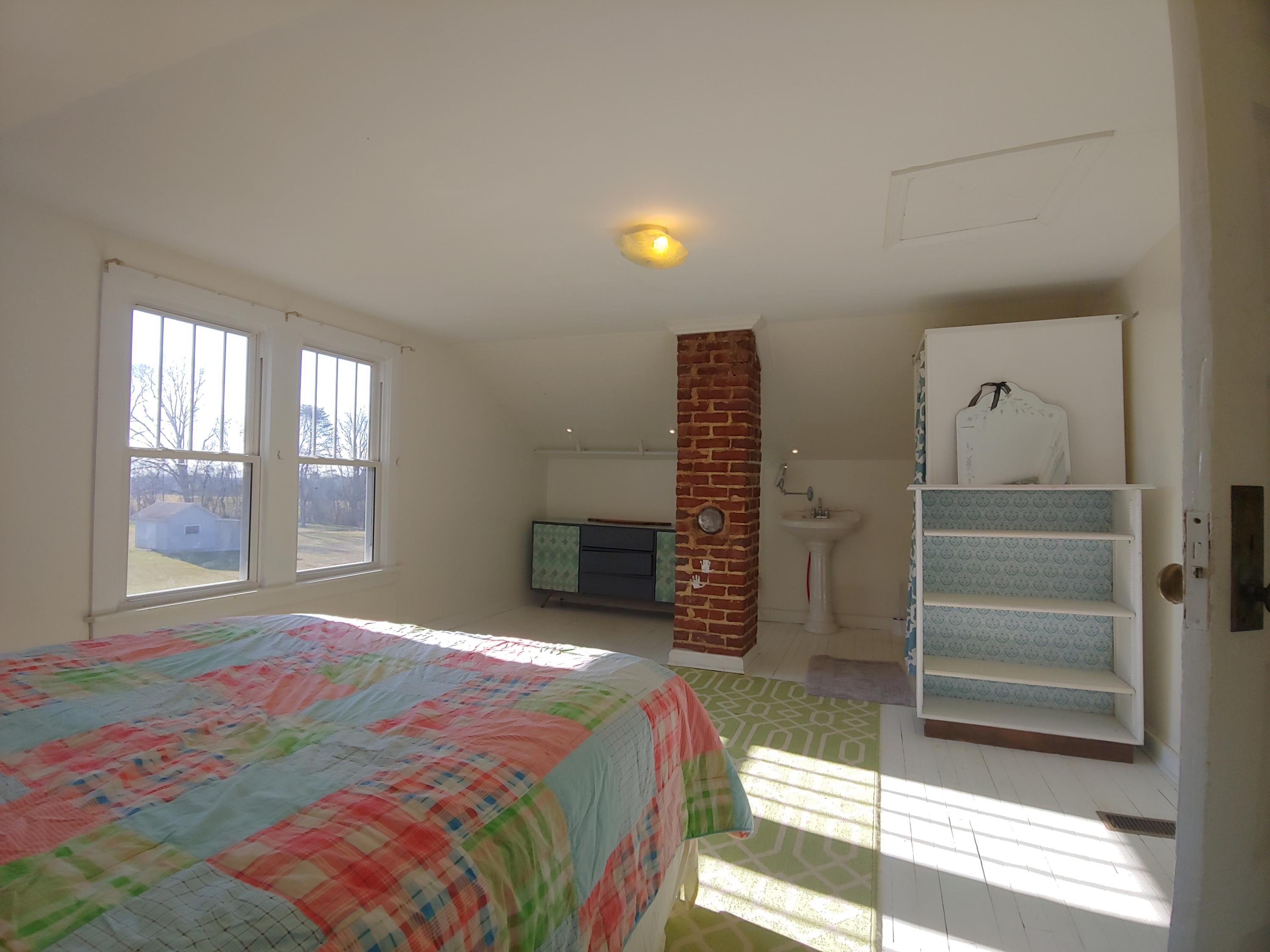 9313 Museville Road Sandy Level, VA 24161 - Photo 33 of 41 a bedroom with a bed and a lamp next to a window
