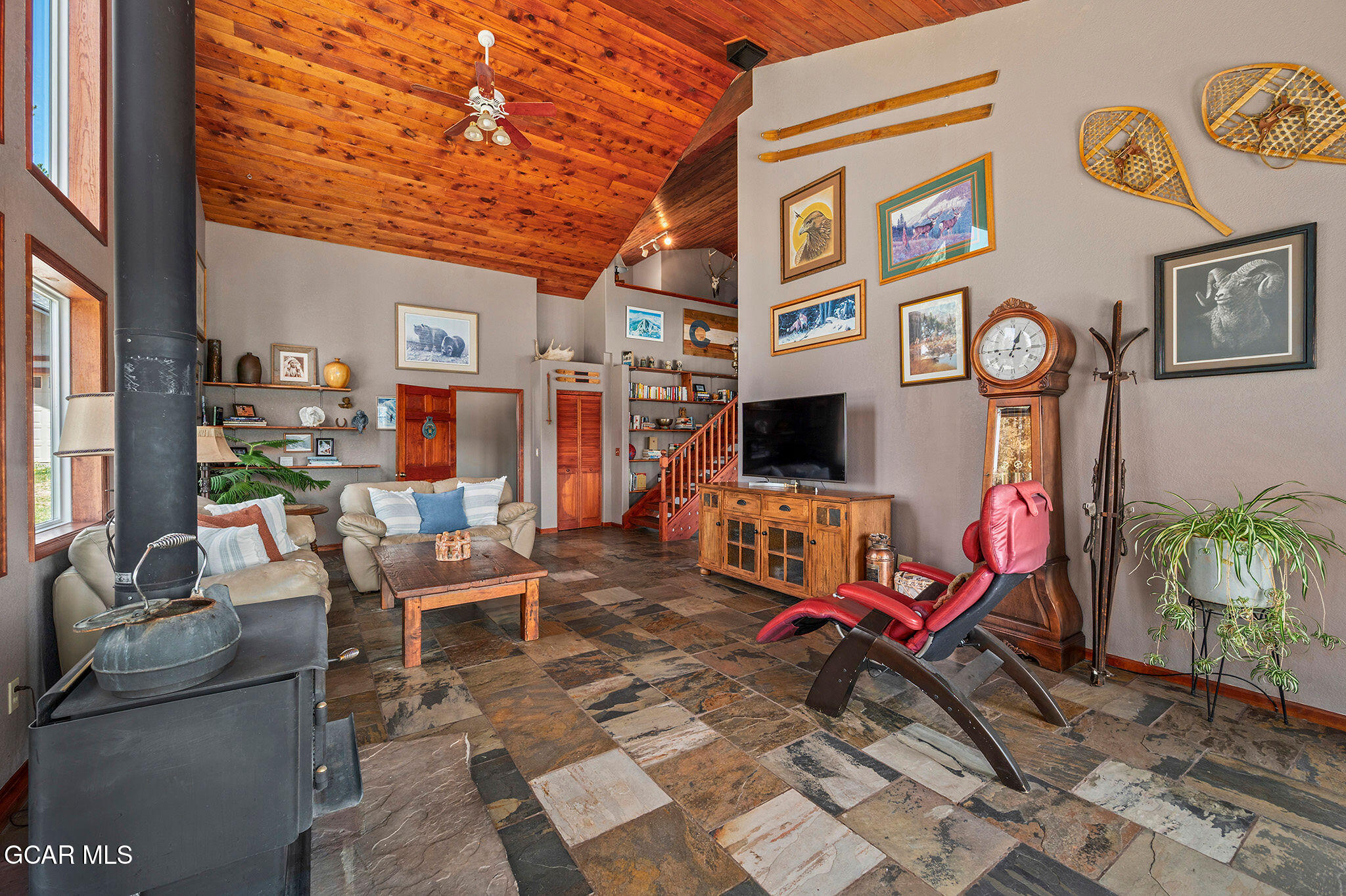 732 Gcr 8311/ Clayton Ranch Road Tabernash, CO 80478 - Photo 7 of 65 a living room with furniture a clock and a flat screen tv