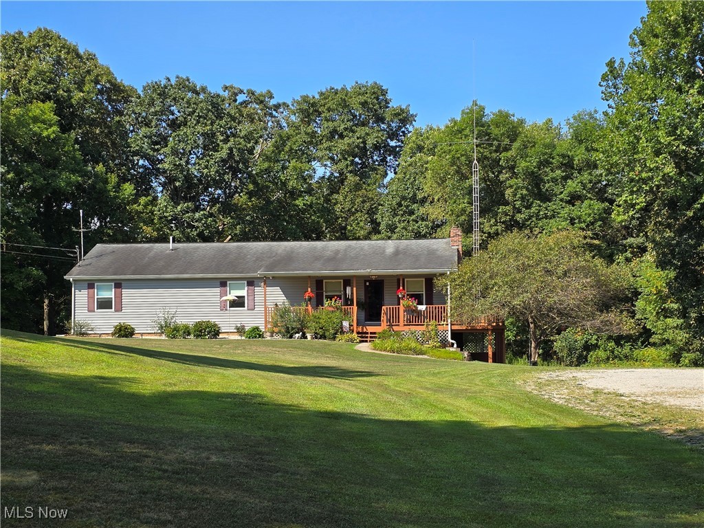 33 Lane Road Vincent, OH 45784 - Photo 1 of 36 View of front facade featuring a wooden deck and a front yard