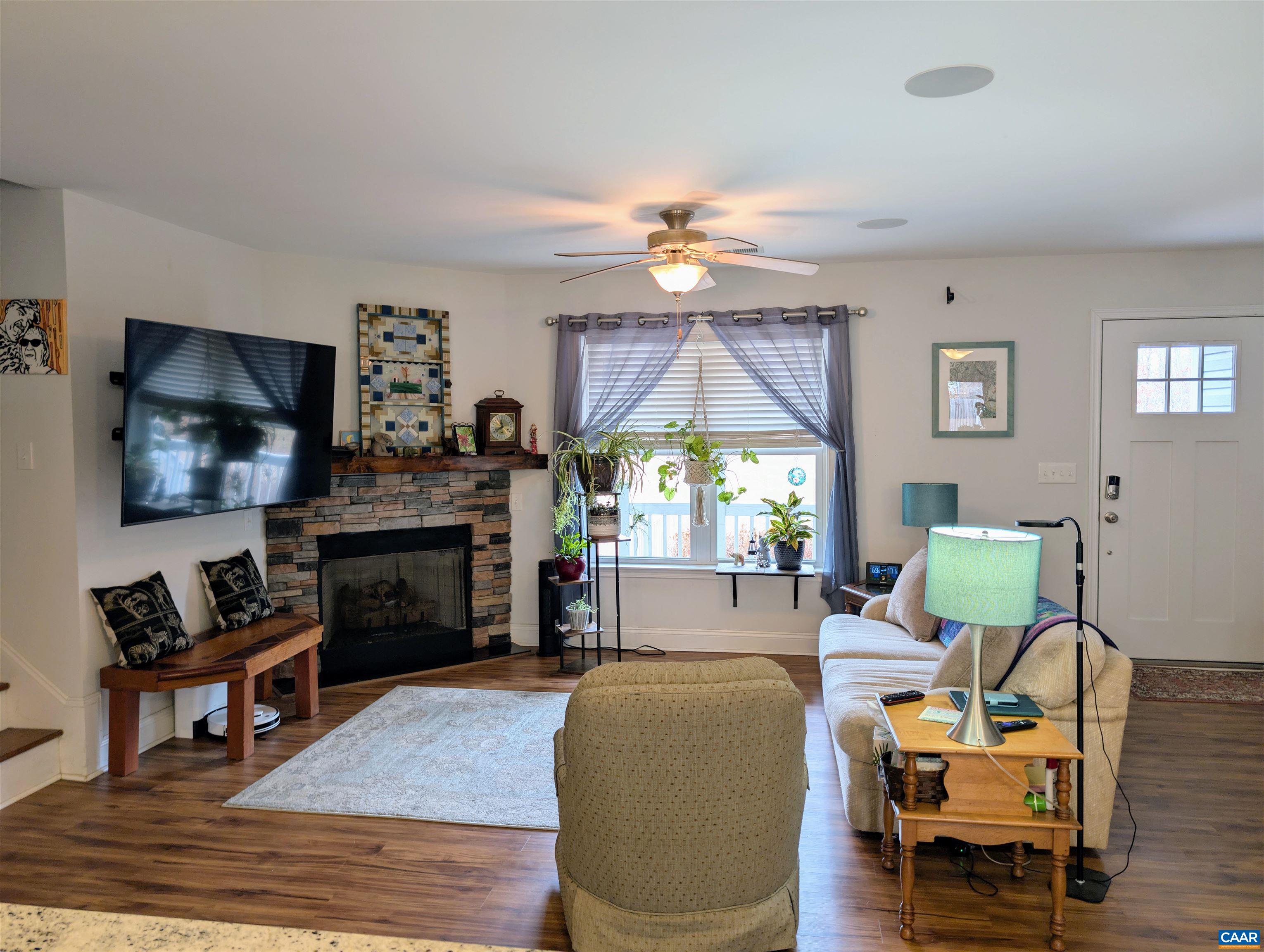 4489 Campbell Road Troy, VA 22974 - Photo 11 of 33 a living room with furniture a fireplace and a flat screen tv